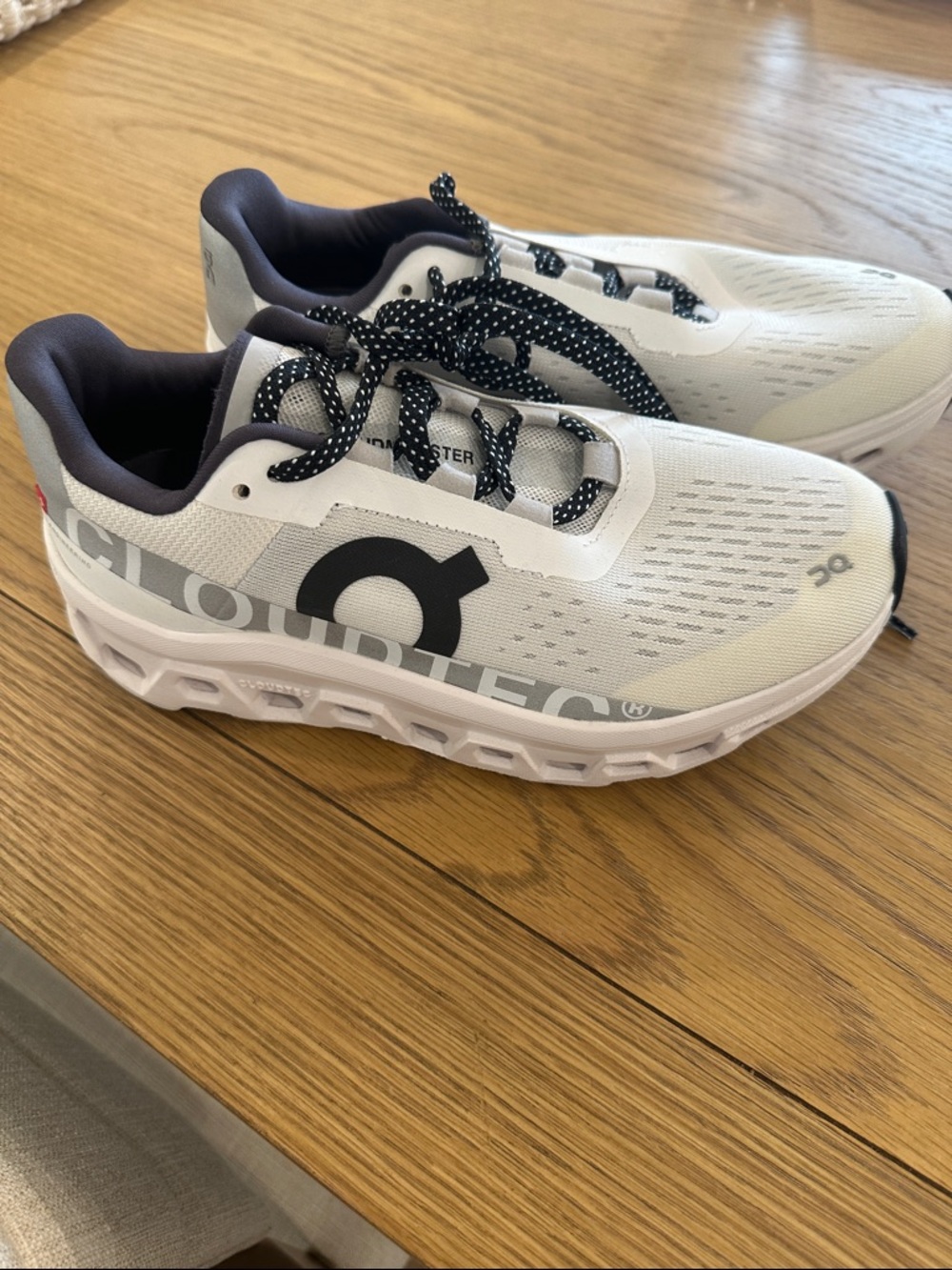 On Running White and Black Cloudtec Cloudmonster Athletic Sneakers